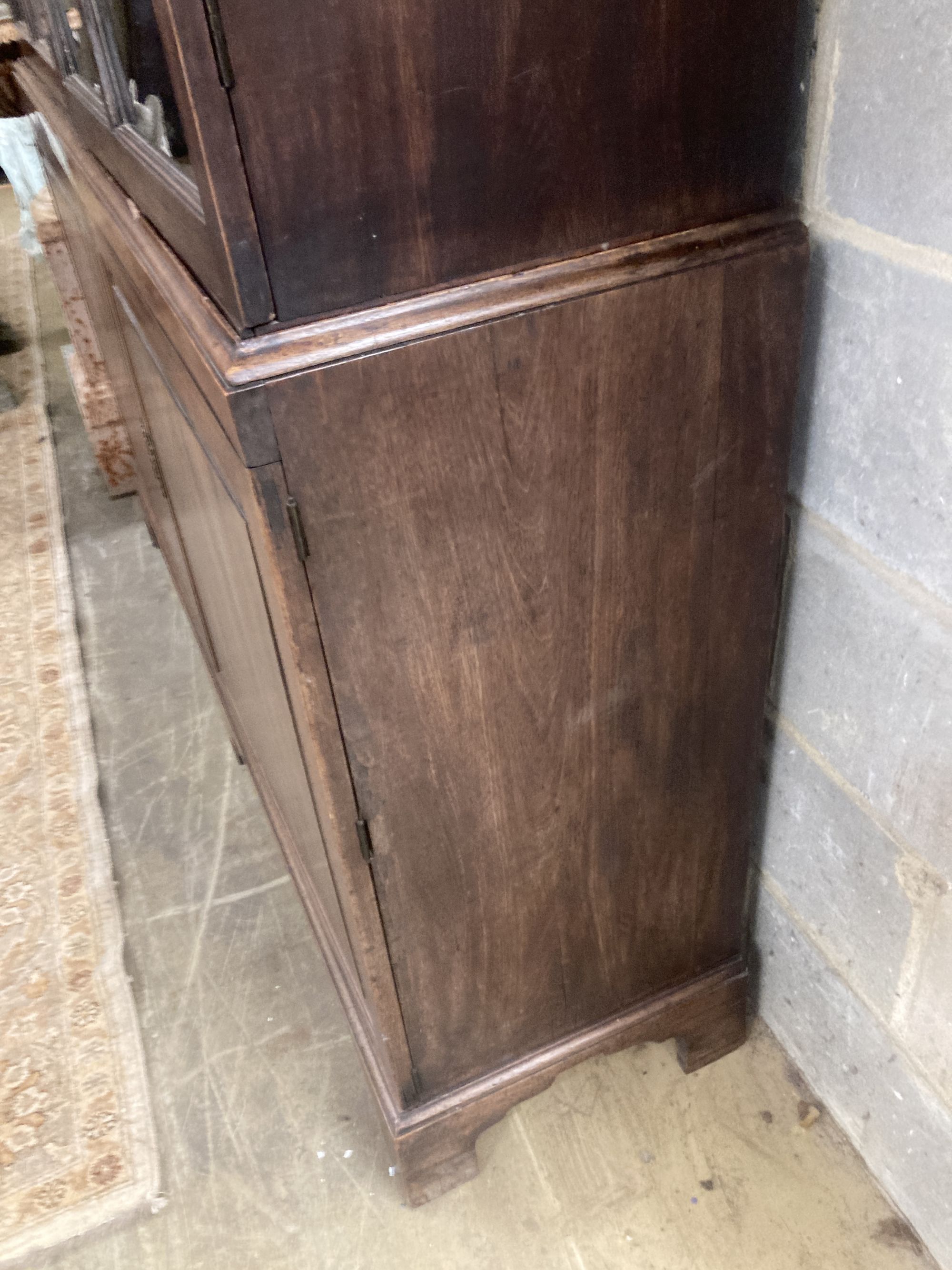 A George III mahogany bookcase cupboard, length 160cm, depth 40cm, height 245cm